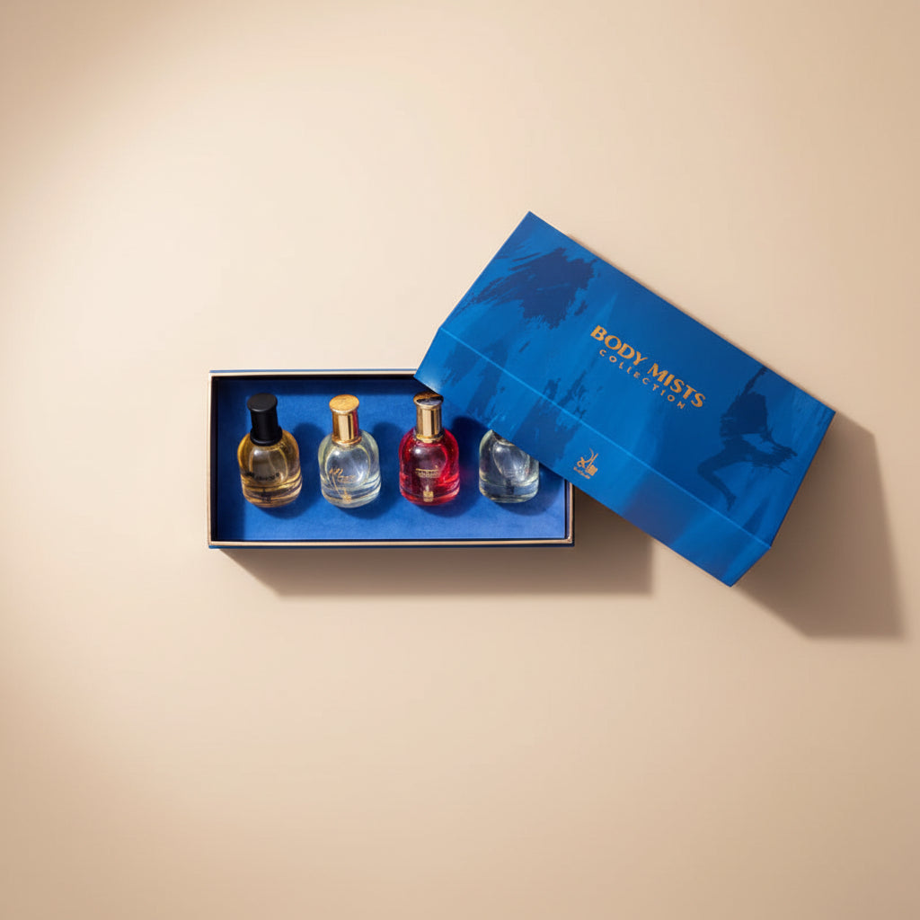 Set of four perfume bottles in a blue box with a matching lid on a dark background