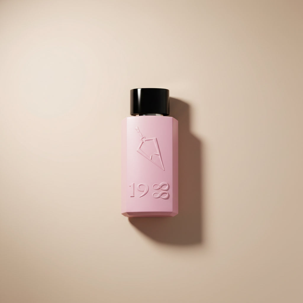 Pink perfume bottle in an open pink box on a white background