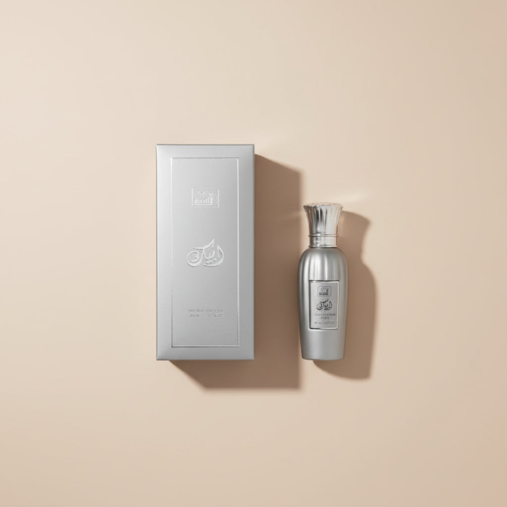 Silver perfume bottle and packaging with branding on a white background