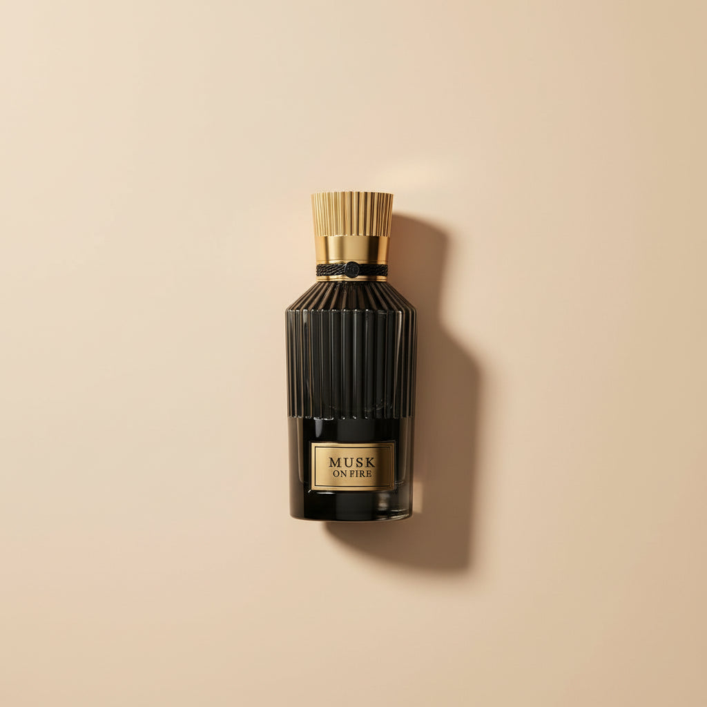 Black perfume bottle with gold cap and label on a white background