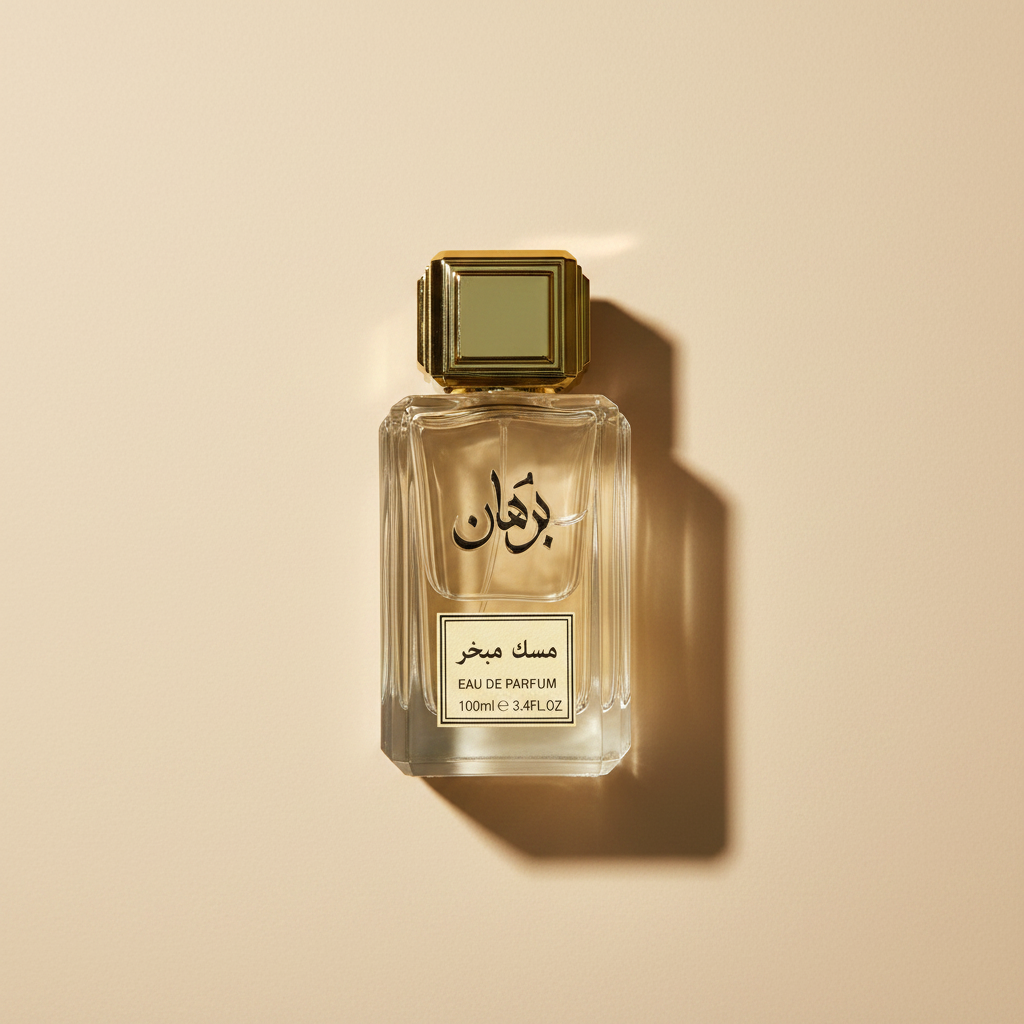 Perfume bottle with gold cap and clear glass body on a white background