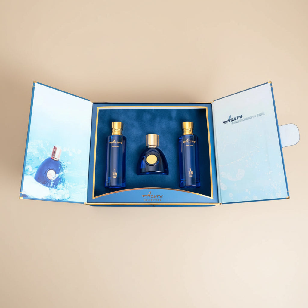 Set of three blue bottles with gold caps in a branded box on a white background