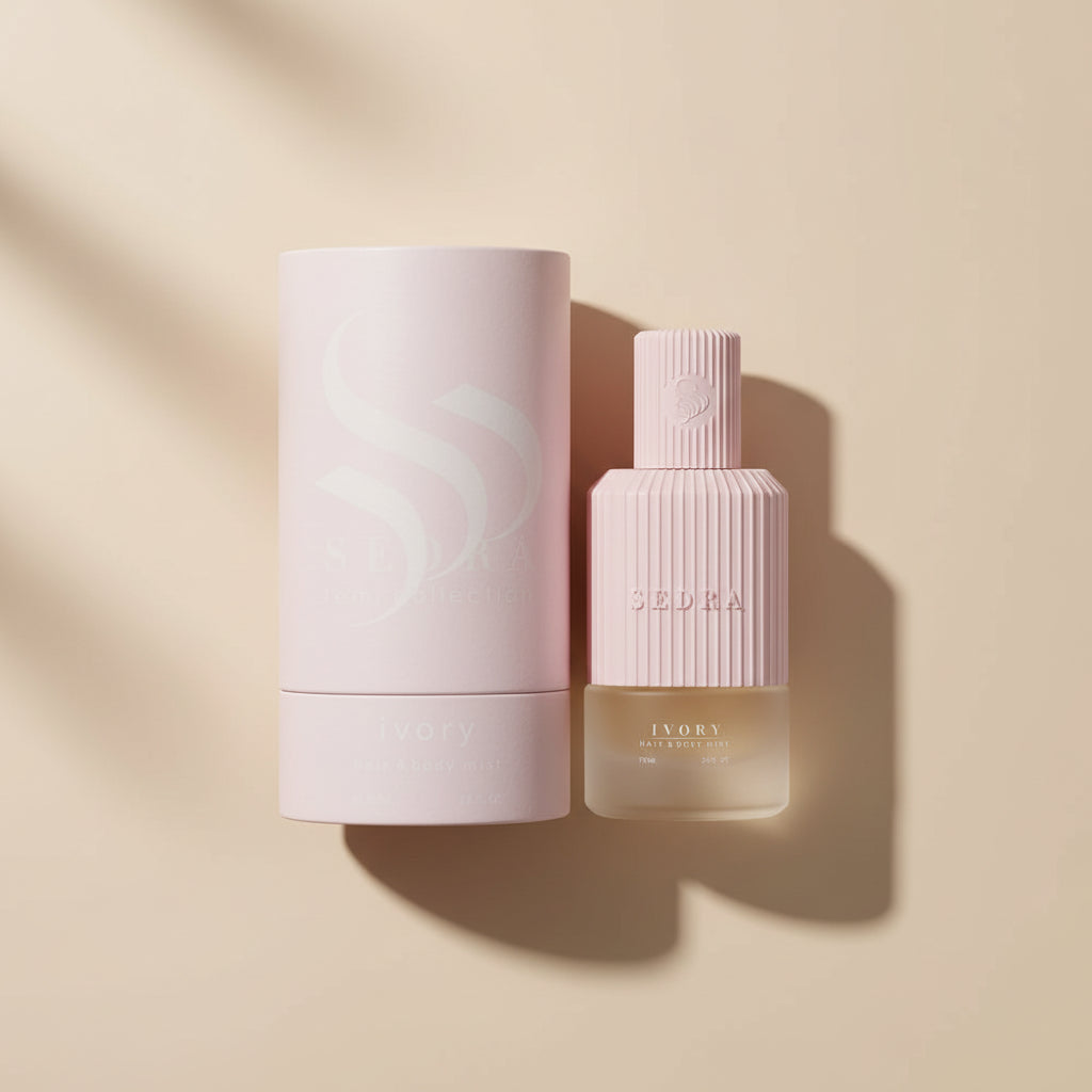 Pink perfume bottle and packaging on a white background