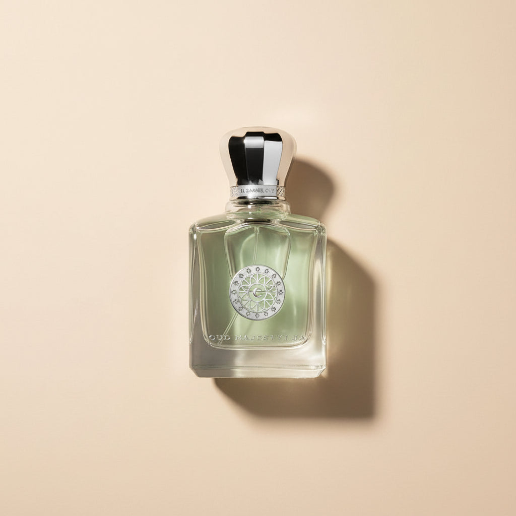 Perfume bottle with silver cap and decorative label on a white background