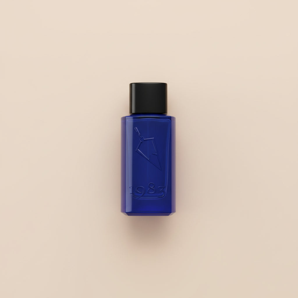 Blue perfume bottle and box with '1983' branding on a white background