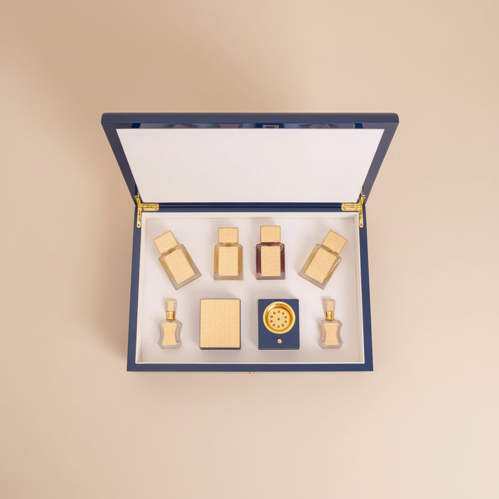Set of perfume bottles in a blue and gold box on a dark background