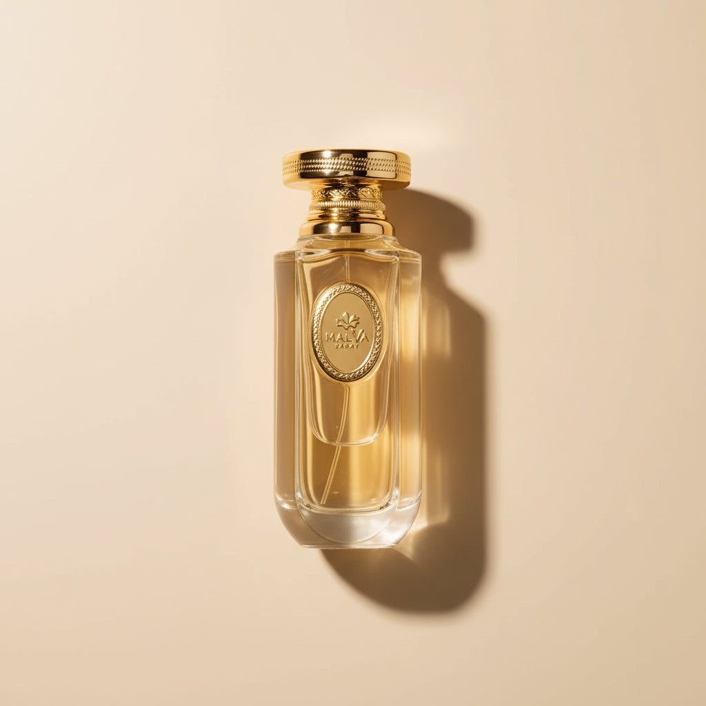 Perfume bottle and packaging with gold accents on a white background