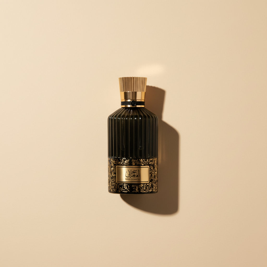 Black perfume bottle with gold cap and label on a white background