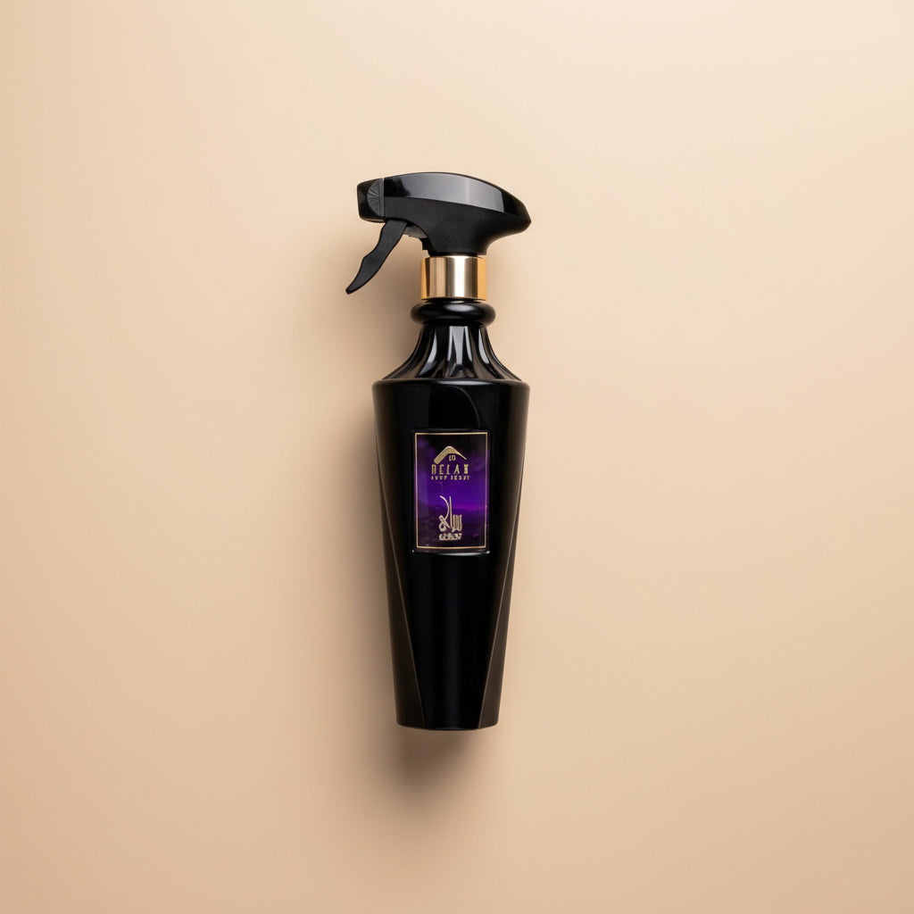 Black perfume bottle with spray nozzle and matching cylindrical packaging on a white background